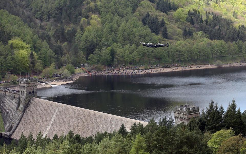 A Lancaster bomber flies over Ladybower reservoir in the Derbyshire Peak District to mark the 70th anniversary of the World War Two - Credit: Christopher Furlong/Getty Images