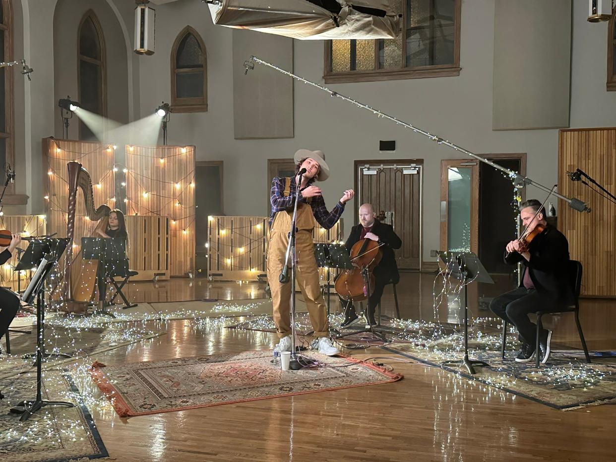 Singer Brandon Ratcliff records a song at Ocean Way studios in Nashville as part of the String Lights Symphony, which is a project by classical musician Charles Dixon, seen here at right playing violin.