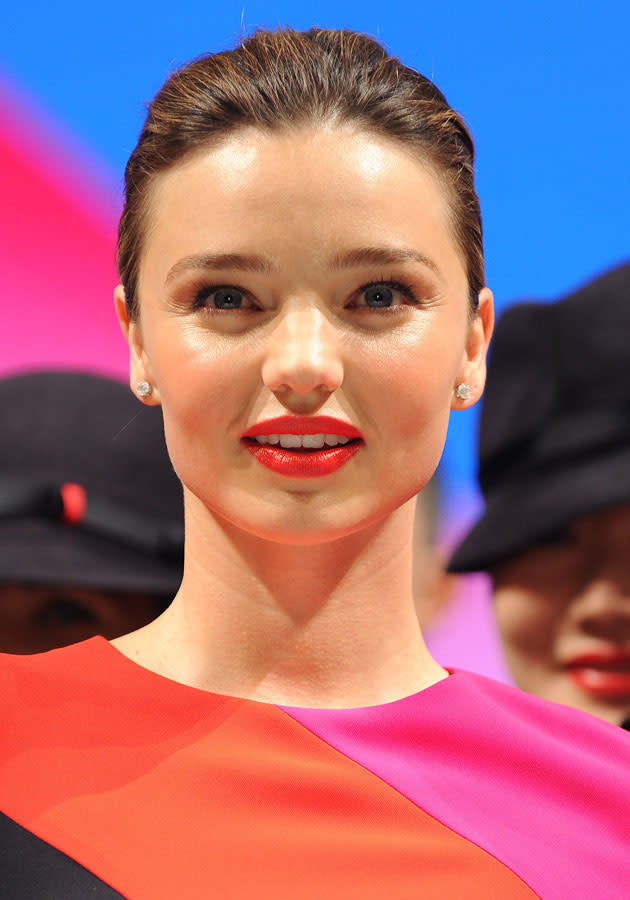 Celebrities wearing red lipstick: Miranda Kerr styled her red lips with a <a href="http://uk.lifestyle.yahoo.com/photos/celebrities-neon-fashion-trend-outfits-looks-style-slideshow/" data-ylk="slk:neon;elm:context_link;itc:0;sec:content-canvas;outcm:mb_qualified_link;_E:mb_qualified_link;ct:story;" class="link  yahoo-link">neon</a> dress.<br><br>[Splash]