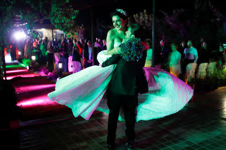 Christian couple Ruba and Antoun, both 31, hug each-other during their wedding outside Damascus, Syria, September 14, 2018. REUTERS/Marko Djurica