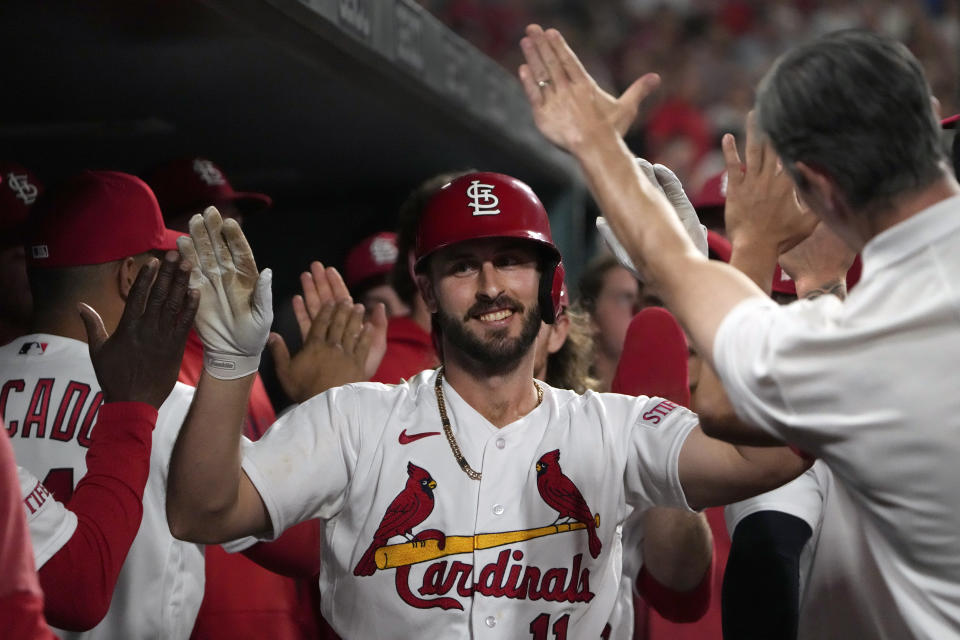 RETRANSMISSION TO CORRECT THAT IT IS A TWO-RUN HOME RUN - St. Louis Cardinals' Paul DeJong is congratulated by teammates after hitting a two-run home run during the sixth inning of a baseball game against the Milwaukee Brewers Wednesday, May 17, 2023, in St. Louis. (AP Photo/Jeff Roberson)