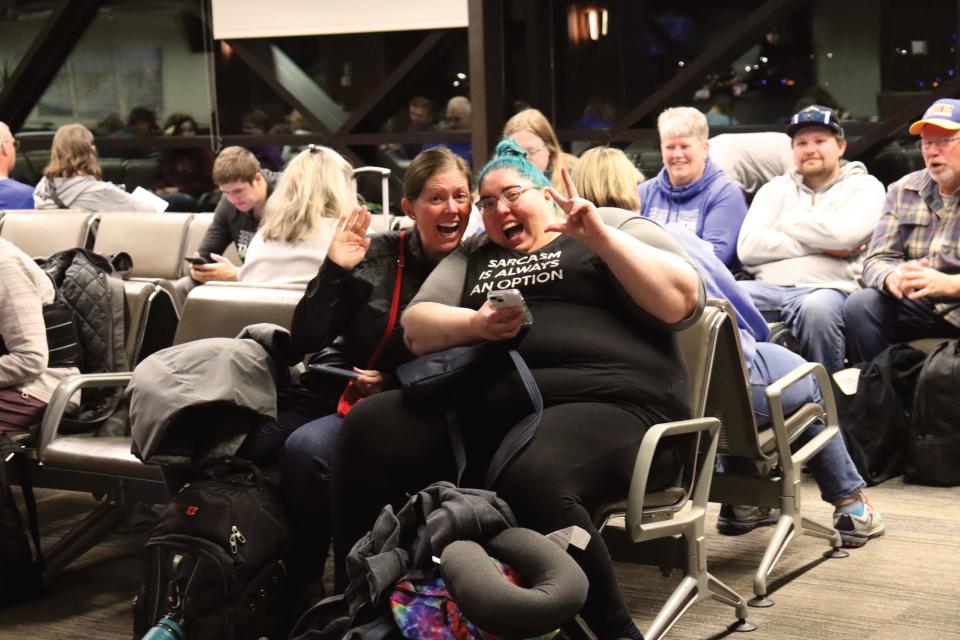 Sisters Lacey Collins and Lindsey Nordsiden chill out in the Sioux Falls airport before the New York flight. Nordsiden is a 2004 SDSU and Pride alumna.