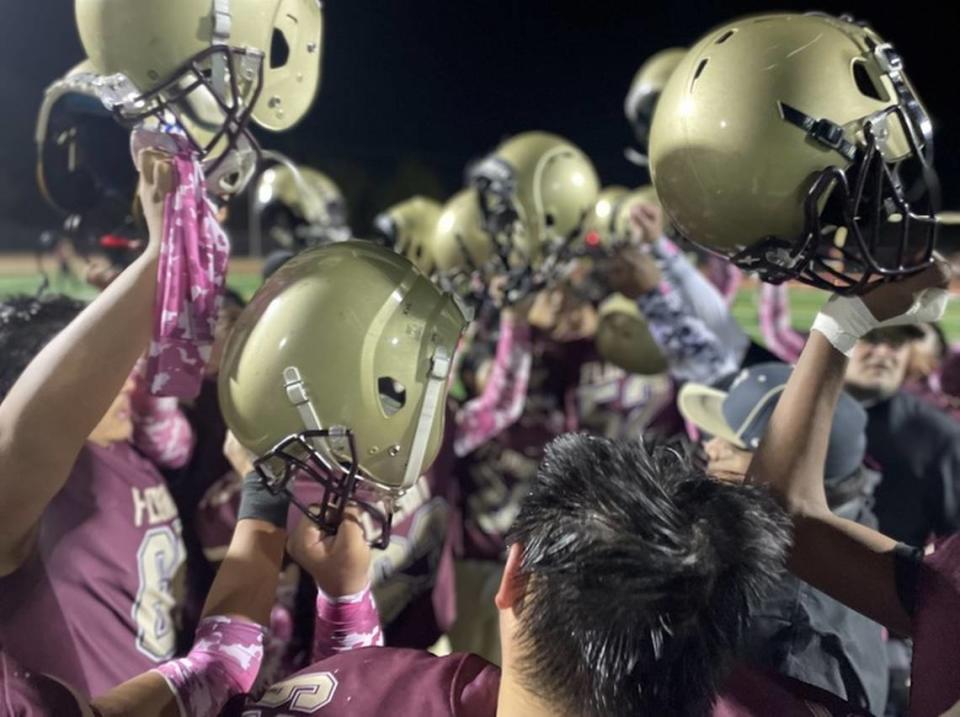 Florin High School varsity football hold their helmets to the sky one final time during the 2023 season.