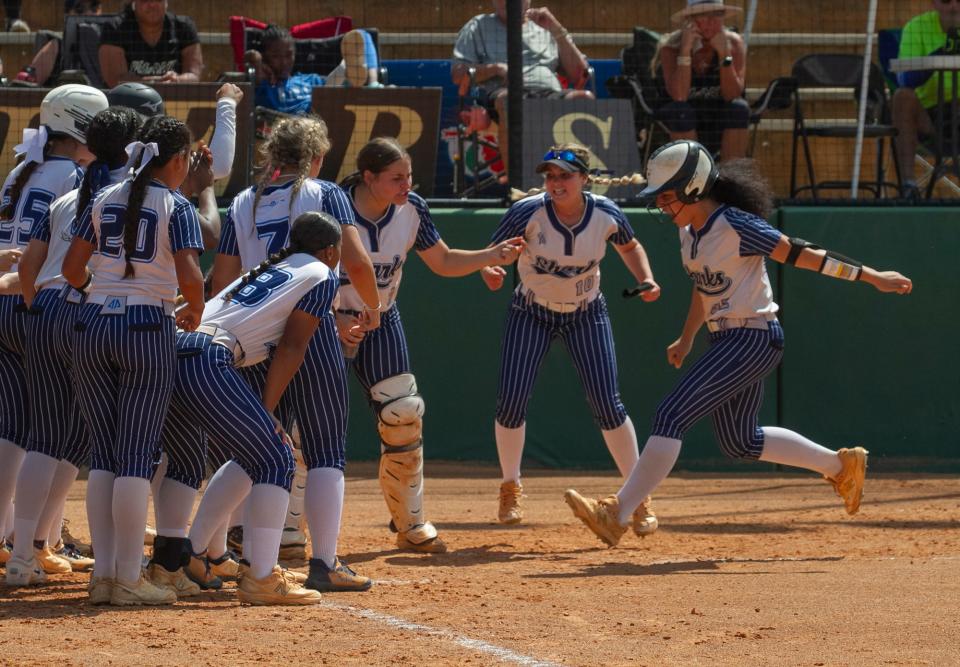 Spanish River High School’s Isabella Santos (42) crosses home plate as the team cheers during the top of the fourth inning against Plant High School during their FHSAA State 7A Championship softball game at the Legends Way Ball Fields in Clermont Saturday. May 27, 2023.