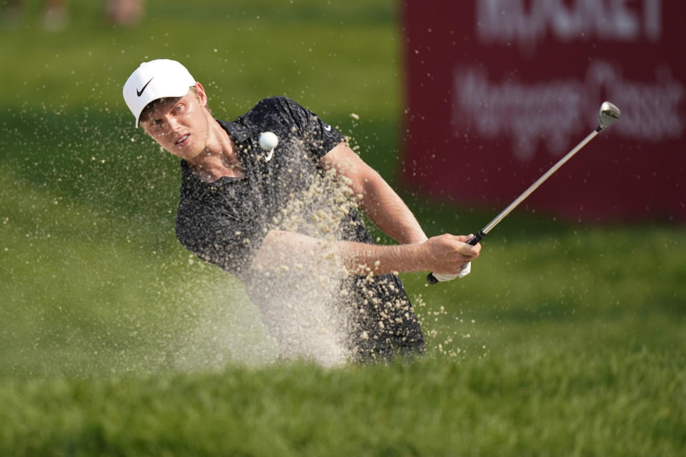 Cam Davis of Australia hits from the sand onto the 17th cup for an eagle during the final round of the Rocket Mortgage Classic golf tournament, Sunday, July 4, 2021, at the Detroit Golf Club in Detroit. (AP Photo/Carlos Osorio)