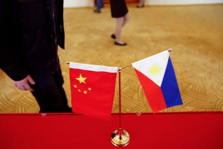 FILE PHOTO: National flags are placed outside a room where Philippine Finance Secretary Carlos Dominguez and China's Commerce Minister Gao Hucheng address reporters after their meeting in Beijing