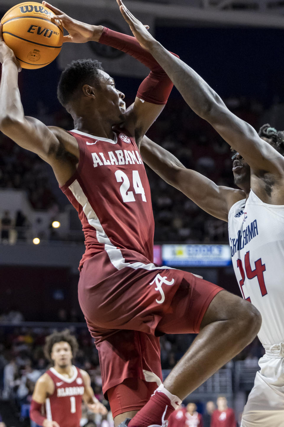 Alabama forward Brandon Miller (24) works for a shot against South Alabama forward Tyler Shirley (24) during the first half of an NCAA college basketball game Tuesday, Nov. 15, 2022, in Mobile, Ala. (AP Photo/Vasha Hunt)