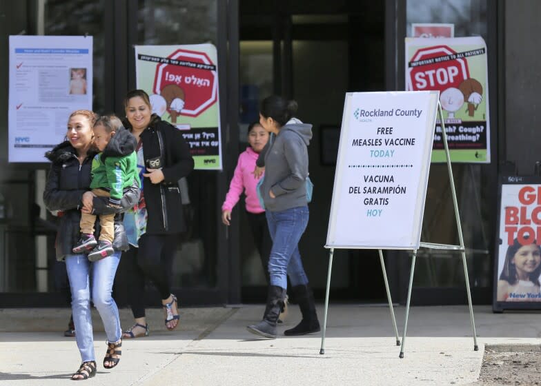 FILE - In this March 27, 2019 file photo, signs advertising free measles vaccines and information about measles are displayed at the Rockland County Health Department, in Pomona, N.Y. A state Supreme Court judge is expected to rule Friday, April 5, on the legality of Rockland County Executive Ed Day's order, banning children from public places unless they've been vaccinated against measles, which is part of efforts to stop a measles outbreak that has infected more than 160 people since October. (AP Photo/Seth Wenig, File)