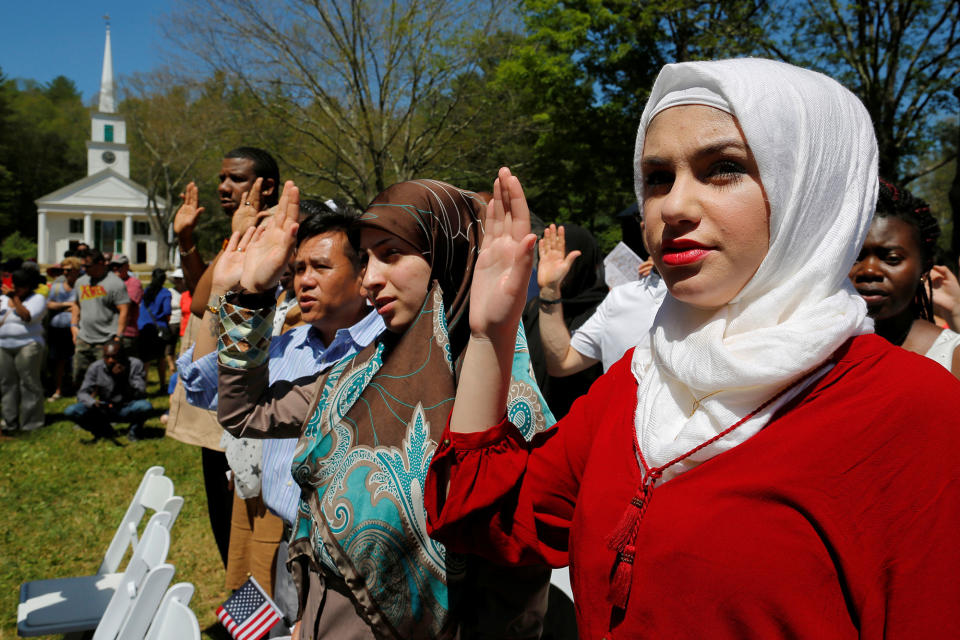 <p>Hala Alhallaq of Iraq takes the Oath of Citizenship as she and 145 others become United States citizens during a naturalization ceremony at Old Sturbridge Village in Sturbridge, Mass., July 4, 2016. (Photo: Brian Snyder/Reuters) </p>