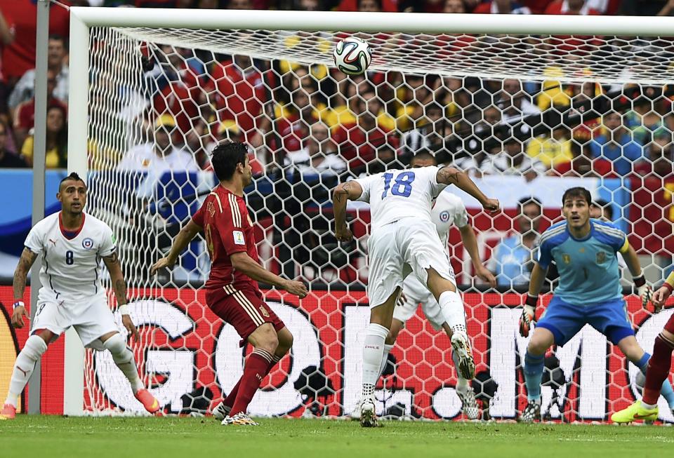 Chile's Gonzalo Jara (18) heads the ball during the 2014 World Cup Group B soccer match between Spain and Chile at the Maracana stadium in Rio de Janeiro June 18, 2014. REUTERS/Dylan Martinez (BRAZIL - Tags: SOCCER SPORT WORLD CUP)