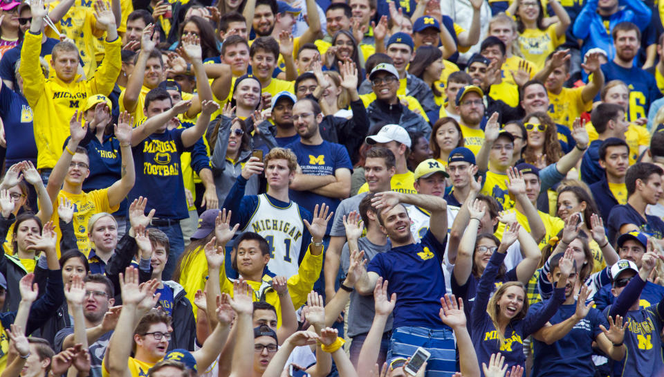 FILE - Fans in the Michigan Stadium student section cheer during an NCAA college football game against UNLV in Ann Arbor, Mich., Saturday, Sept. 19, 2015. After statewide bans on affirmative action in states from California to Florida, colleges have tried a range of strategies to achieve a diverse student body – giving greater preference to low-income families and admitting top students from communities across their states. But after years of experimentation, some states requiring race-neutral policies have seen drops in Black and Hispanic enrollments. (AP Photo/Tony Ding, File)