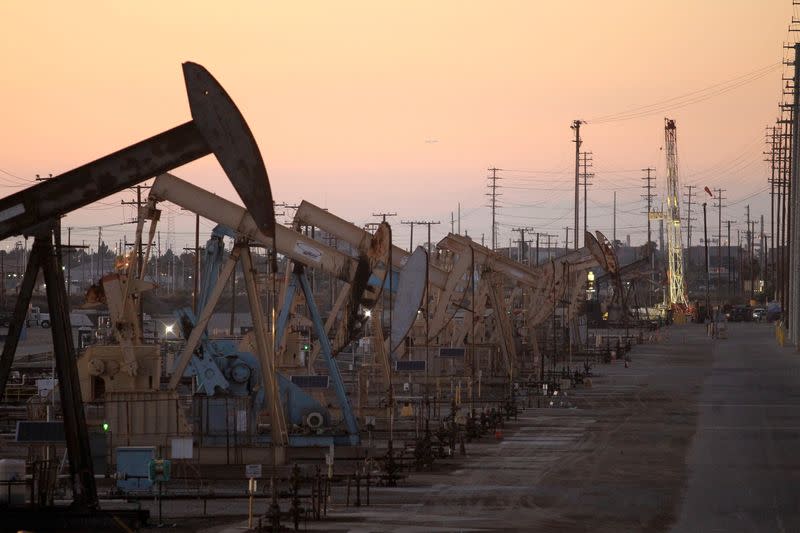 FILE PHOTO: Oil rig pumpjacks extract crude from the Wilmington Field oil deposits area where Tidelands Oil Production Company operates near Long Beach, California