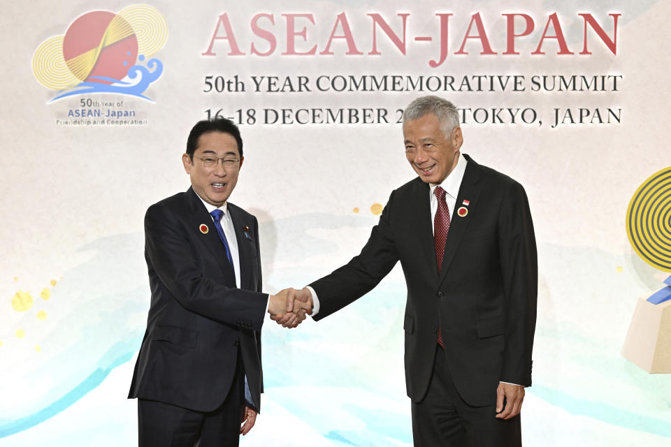 Japan's Prime Minister Fumio Kishida, left, greets Singapore's Prime Minister Lee Hsien Loong upon arrival for the opening session of ASEAN-Japan Commemorative Summit Meeting at the Hotel Okura Tokyo in Tokyo Sunday, Dec. 17, 2023. (Kazuhiro Nogi/Pool Photo via AP)