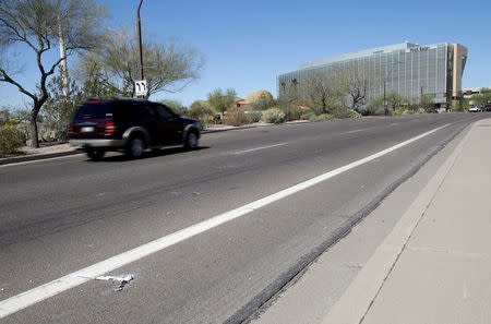 Burned out flares lie at the location where a woman pedestrian was struck and killed by an Uber self-driving sport utility vehicle in Tempe, Arizona, U.S., March 19, 2018. REUTERS/Rick Scuteri