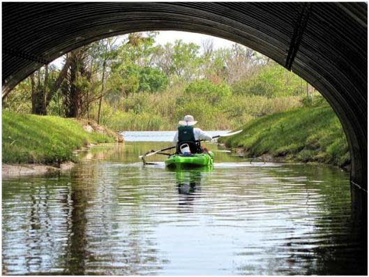 A kayaker between lakes in Ormond Beach's Central Park.