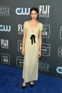 <p>Margaret Qualley's cream-and-black dress is a charming look on the blue carpet.</p>