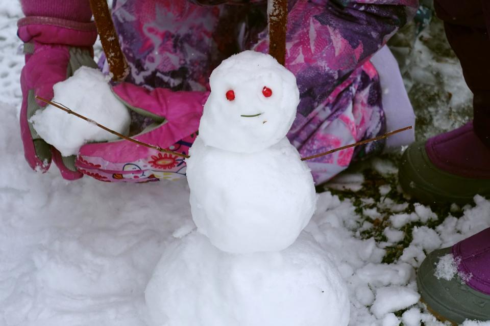 Kids make a mini snowman in East Providence on 2022's first big snowfall, which arrived just after the holidays, on Jan 7.