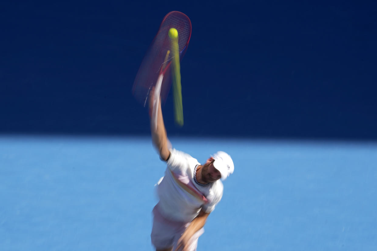 Tommy Paul of the U.S. serves to compatriot Ben Shelton during their quarterfinal match at the Australian Open tennis championship in Melbourne, Australia, Wednesday, Jan. 25, 2023. (AP Photo/Ng Han Guan)