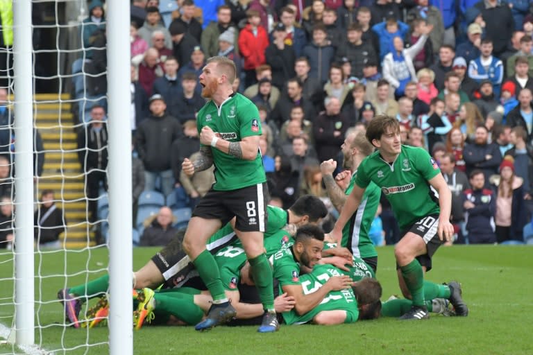 Lincoln City players celebrate after scoring against Premier League side Burnley in the fifth round of the FA Cup on February 18, 2017