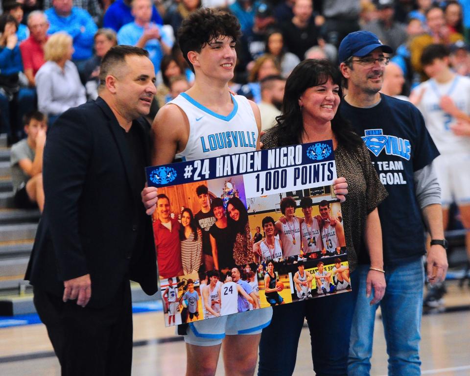 Louisville's Hayden Nigro is recognized after scoring his 1,000th career point in the second quarter of a game against Hoban, Friday, Dec. 15, 2023.