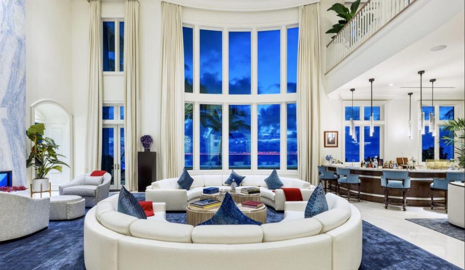 The living room of a Manalapan home just listed for $89 million has double-height windows that capture views of the Atlantic Ocean.