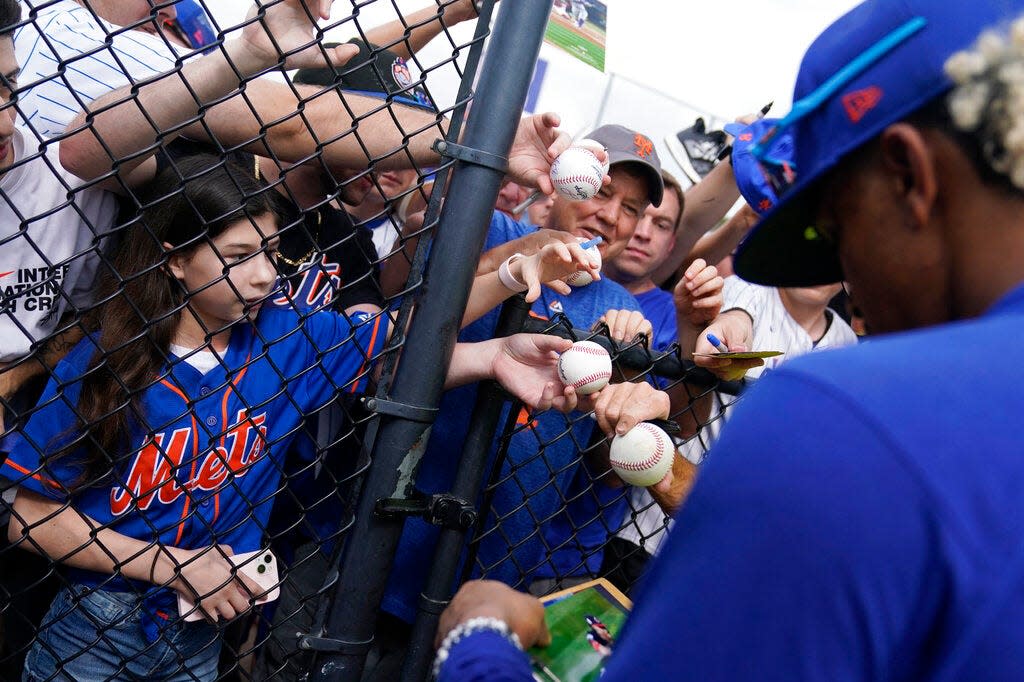 Fans jockey for position to get an autograph from New York Mets shortstop Francisco Lindor during spring training baseball practice Thursday, Feb. 16, 2023, in Port St. Lucie, Fla. (AP Photo/Jeff Roberson)