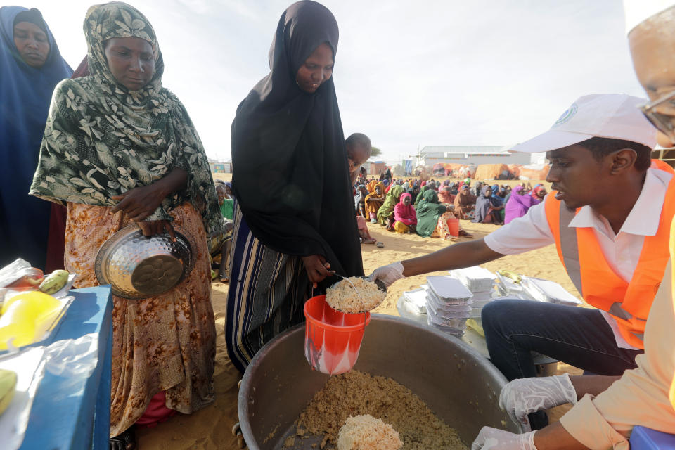 Local NGO prepare Iftar food for people at an internally displaced people camp on the outskirts of Mogadishu, Somalia, Friday, March 24, 2023. This year's holy month of Ramadan coincides with the longest drought on record in Somalia. (AP Photo/Farah Abdi Warsameh)