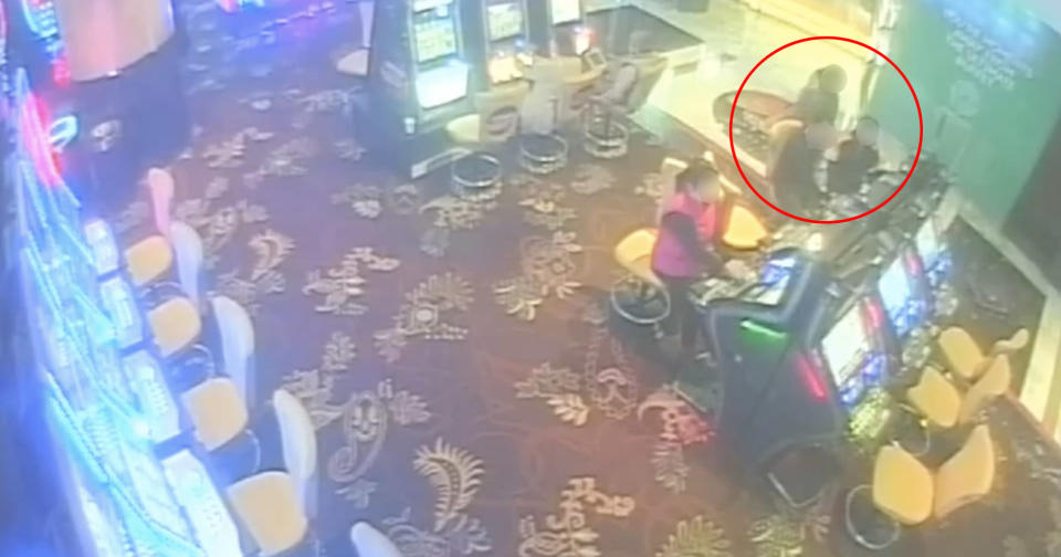 The girl is seen sitting alongside her mother inside the casino. 