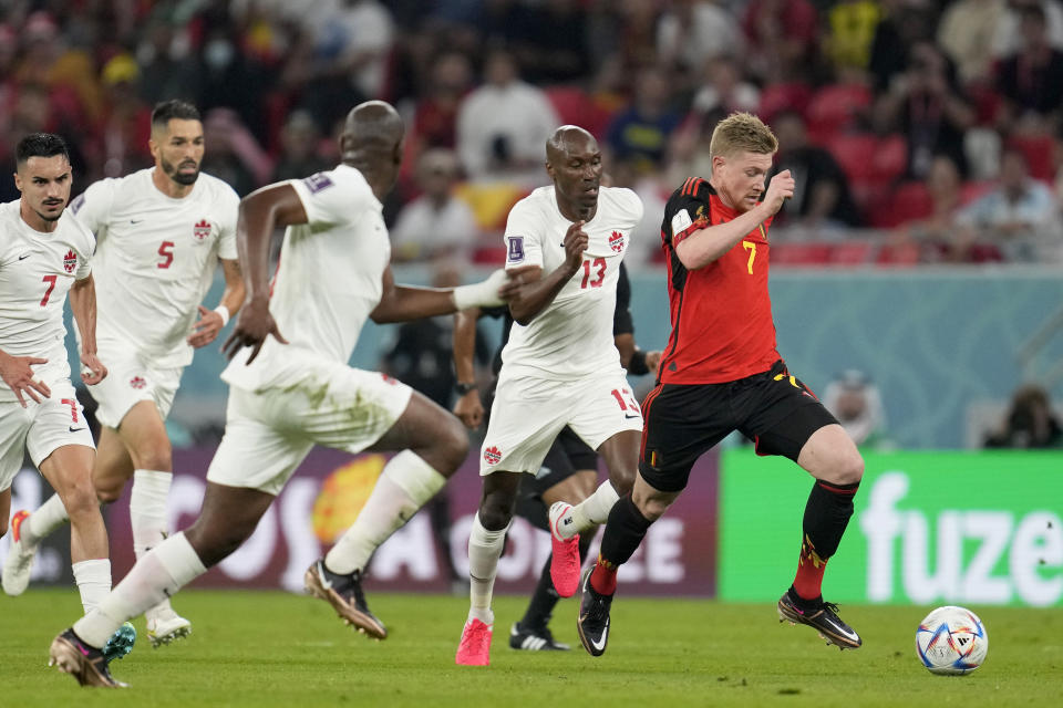 Belgium's Kevin De Bruyne, right, runs with the ball during the World Cup group F soccer match between Belgium and Canada, at the Ahmad Bin Ali Stadium in Doha, Qatar, Wednesday, Nov. 23, 2022. (AP Photo/Natacha Pisarenko)