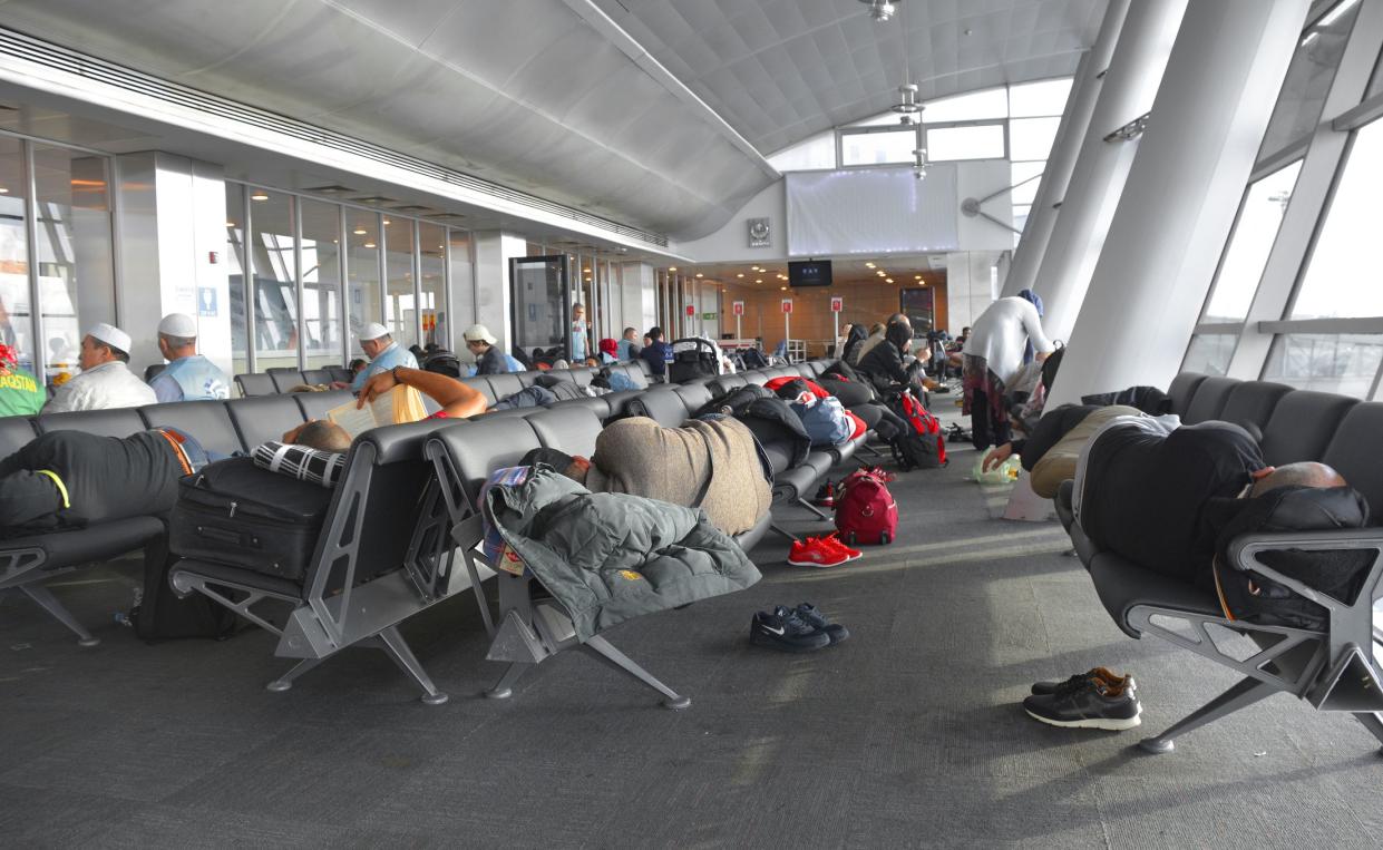 Istanbul, Turkey - January 4th 2018. Passengers with long layovers try to catch some sleep between flights at a gate at Istanbul Ataturk Airport