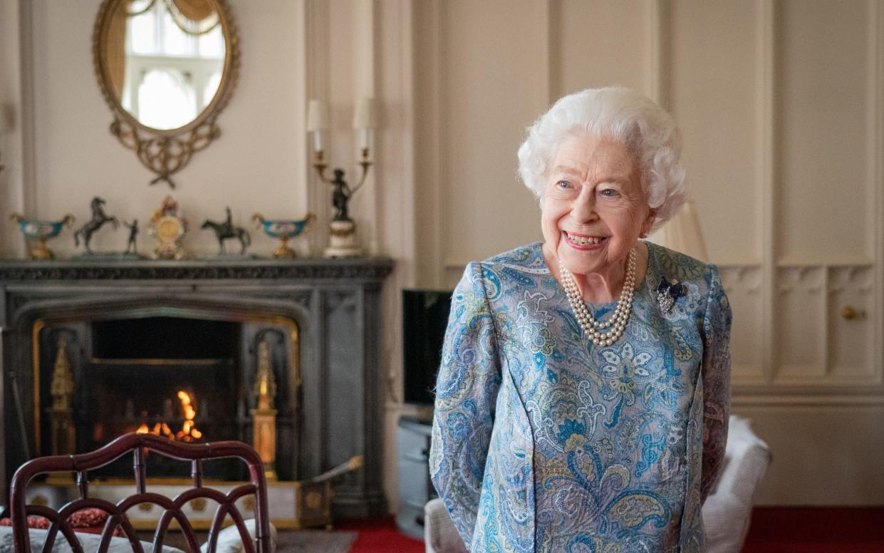 The monarch smiles broadly in the Oak Room at Windsor Castle - Dominic Lipinski/AFP via Getty Images 