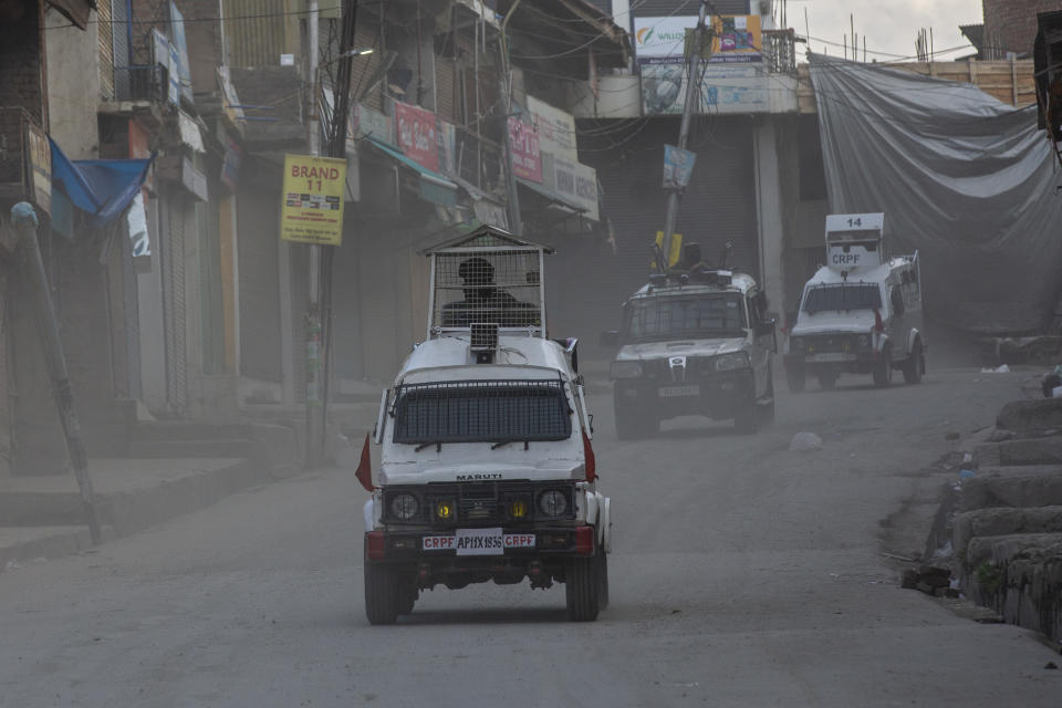 Government forces leave the site of a gunbattle in Shopian, south of Srinagar, Indian controlled Kashmir, Friday, April 9, 2021. Seven suspected militants were killed and four soldiers wounded in two separate gunfights in Indian-controlled Kashmir, officials said Friday, triggering anti-India protests and clashes in the disputed region. (AP Photo/ Dar Yasin)