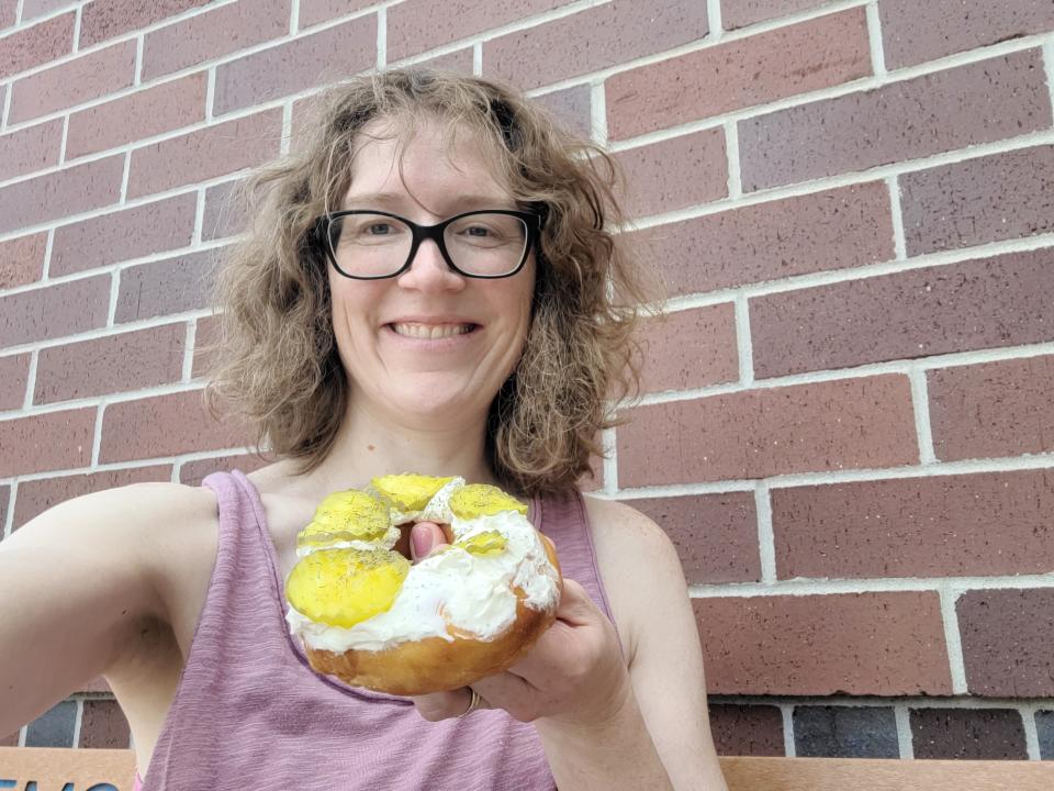 Reporter Amy Schwabe tries a dill pickle doughnut from Fluffy's Hand Cut Donuts at the Wisconsin State Fair.