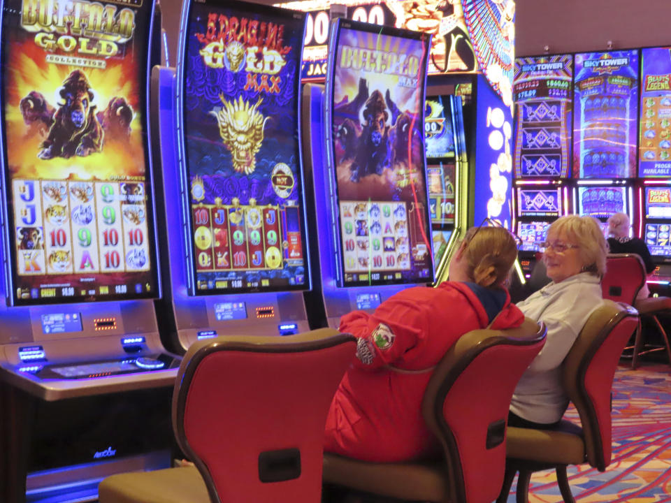 Gamblers play slot machines at the Hard Rock casino in Atlantic City, N.J., on May 17, 2023. Figures released on Aug. 22, 2023, by the New Jersey Division of Gaming Enforcement show Atlantic City's nine casinos posted a gross operating profit of nearly $146 million in the second quarter of this year. That is down 20.5% from the same period a year ago, and also less than the $159 million operating profit they posted in the second quarter of 2019. (AP Photo/Wayne Parry)