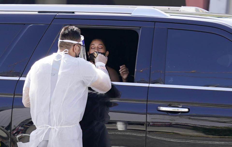 Actress Tracee Ellis Ross gets a coronavirus test as she arrives for the 72nd Primetime Emmy Awards at Staples Center, Sunday, Sept. 20, 2020, in Los Angeles. (AP Photo/Chris Pizzello)