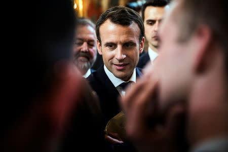 French President Emmanuel Macron talks with guests after he delivered a speech to the young French farmers invited at the Elysee Palace before the opening of the 2018 Paris International Agricultural Show in Paris, France, February 22, 2018. REUTERS/Etienne Laurent/Pool