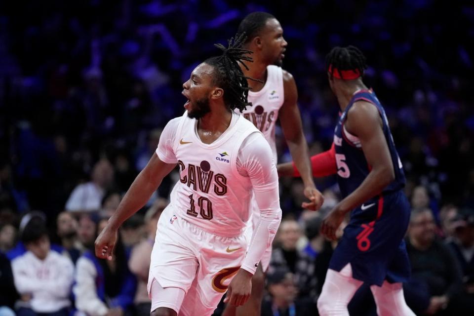 Cavaliers guard Darius Garland, left, reacts after a basket during the second half at Philadelphia, Nov. 21, 2023.