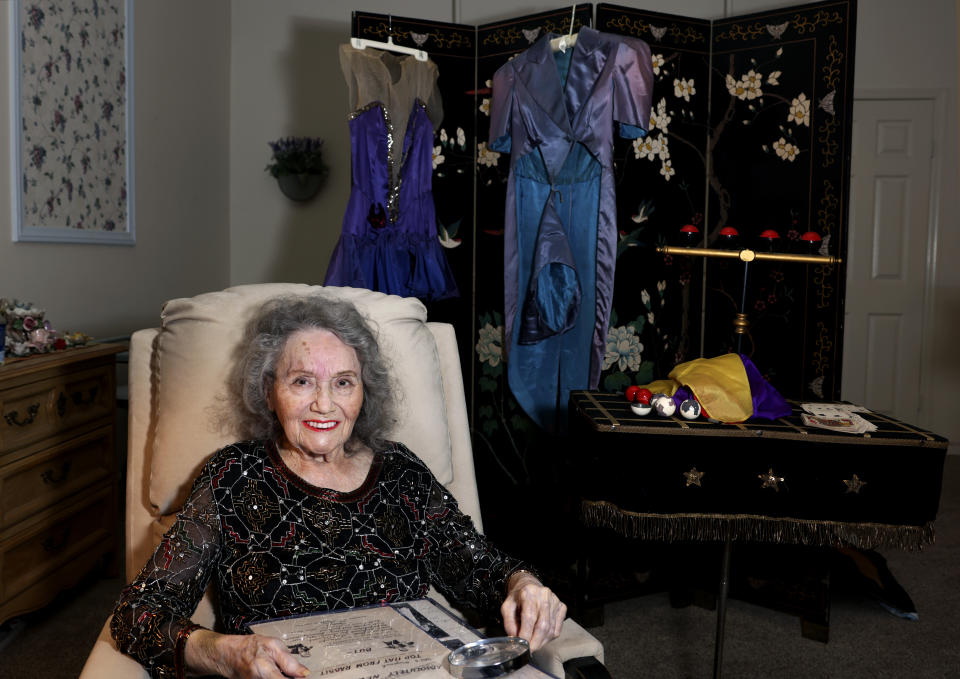 Magician Gloria Dea looks at old photos at her Las Vegas home on Tuesday, Aug. 9, 2022. Dea, touted as the first magician to perform on what would become the Las Vegas Strip in the early 1940s, has died. One of Dea's caretakers said she died Saturday, March 18, 2023, at her Las Vegas residence. She was 100. (K.M. Cannon/Las Vegas Review-Journal via AP)