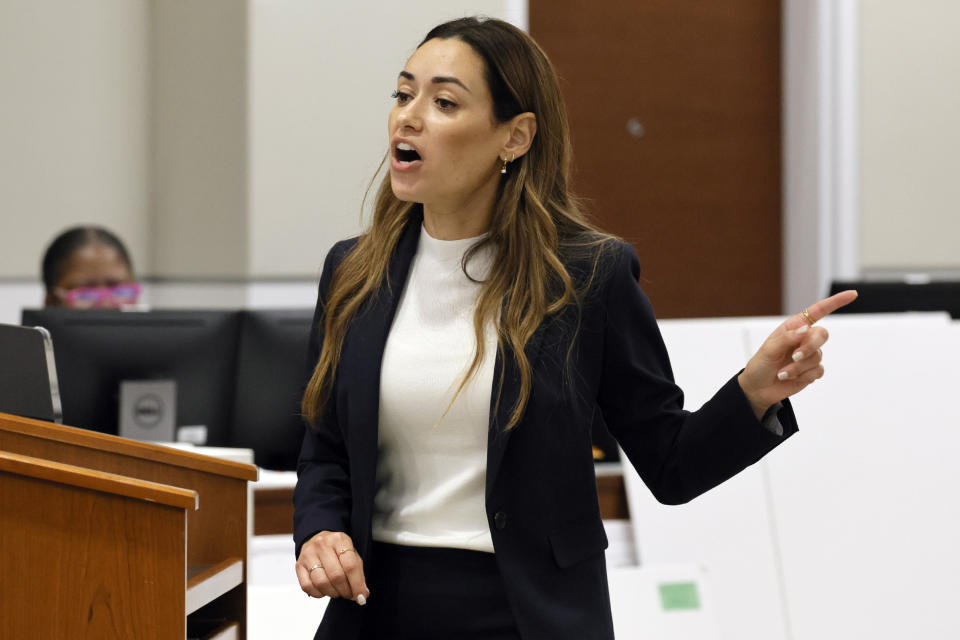 Assistant State Attorney Kristen Gomes motions to the defendant as she gives her closing argument in the trial of former Marjory Stoneman Douglas High School School Resource Officer Scot Peterson, Monday, June 26, 2023, at the Broward County Courthouse in Fort Lauderdale, Fla. Peterson is accused of failing to confront the shooter who murdered 14 students and three staff members at a Parkland high school five years ago. (Amy Beth Bennett/South Florida Sun-Sentinel via AP, Pool)