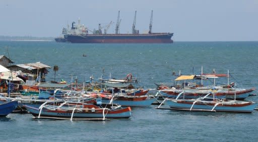 Philippine fishing boats are anchored near a foreign cargo vessel facing the South China sea at the port of Santa Cruz town, Zambales province, north of Manila, on May 10. For years Filipino and Chinese fishermen peacefully shared the rich harvests around a tiny South China Sea shoal, but today threats, harassment and fear have replaced ocean comradery