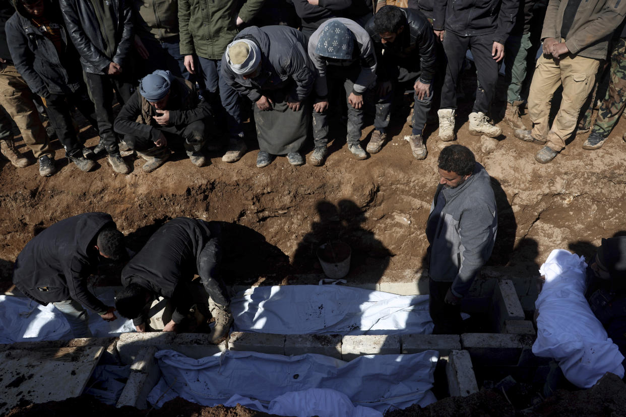 Mourners bury family members who died in a devastating earthquake that rocked Syria and Turkey at a cemetery in the town of Jinderis, Aleppo province, Syria, Tuesday, Feb. 7, 2023. A newborn girl was found buried under debris with her umbilical cord still connected to her mother, Afraa Abu Hadiya, who was found dead, according to relatives and a doctor. The baby was the only member of her family to survive from the building collapse Monday in Jinderis, next to the Turkish border, Ramadan Sleiman, a relative, told The Associated Press. (AP Photo/Ghaith Alsayed)