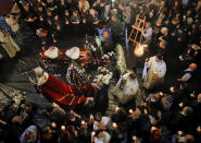 <p>Priests walk by the coffin of Andreea Cristea, who was a victim of the attack on Westminster Bridge, during a religious service in Constanta, Romania, May 13, 2017. A Romanian tourist thrown into the Thames when an extremist plowed into pedestrians on Westminster Bridge, was finally buried in this Black Sea port which was her hometown. Andreea Cristea, 31, was knocked into the river when Khalid Masood drove his rented SUV into pedestrians on Westminster Bridge on March 22. She died two weeks later. Her boyfriend, Andrei Burnaz, who was about to propose, suffered a broken foot. (Photo: Vadim Ghirda/AP) </p>