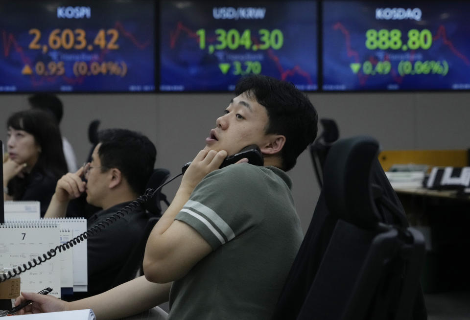 A currency trader watches monitors at the foreign exchange dealing room of the KEB Hana Bank headquarters in Seoul, South Korea, Tuesday, July 4, 2023. Asian stock markets were mixed Tuesday after Wall Street hit a 15-month high ahead of a decision by Australia's central bank on a possible interest rate hike. (AP Photo/Ahn Young-joon)