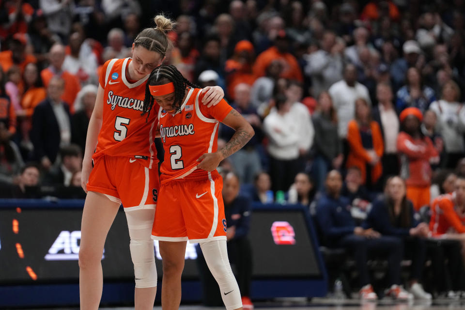 Syracuse's Dyaisha Fair (2) is comforted by teammate Georgia Woolley toward the end of Monday's NCAA tournament second-round loss to UConn in Storrs, Connecticut.  (Photo by Joe Buglewicz/Getty Images)