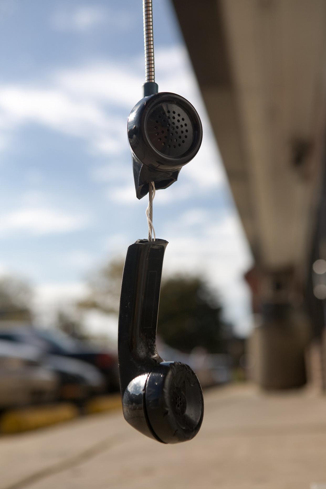 broken telephone receiver hanging