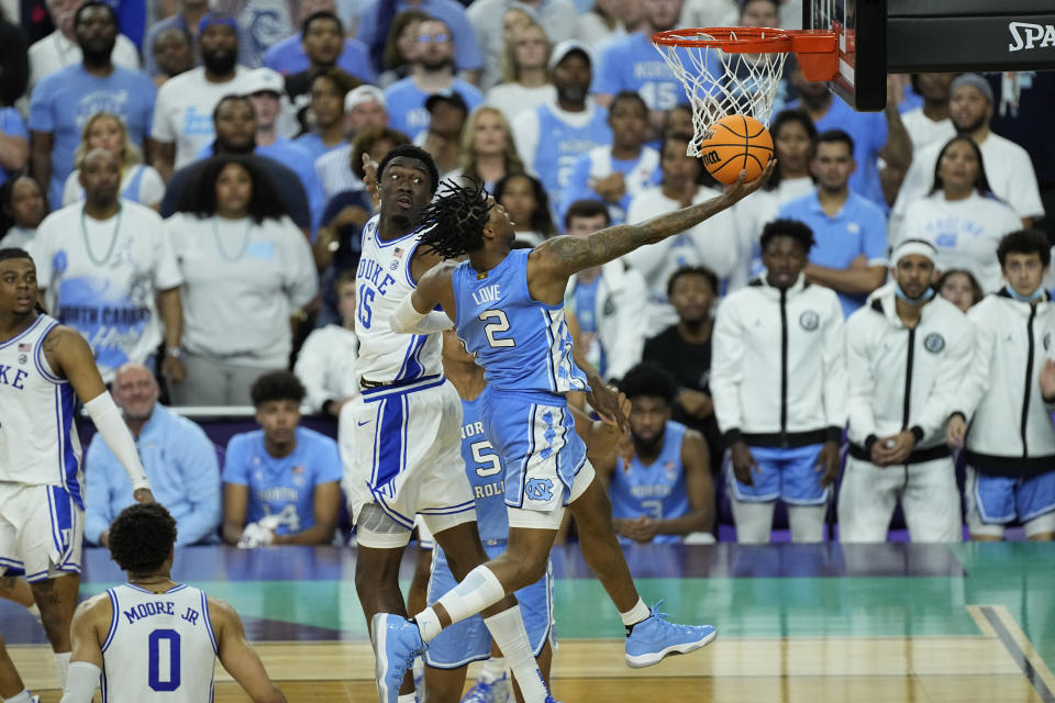 North Carolina guard Caleb Love (2) shoots against Duke center Mark Williams (15) during the second half of a college basketball game in the semifinal round of the Men's Final Four NCAA tournament, Saturday, April 2, 2022, in New Orleans. (AP Photo/Gerald Herbert)