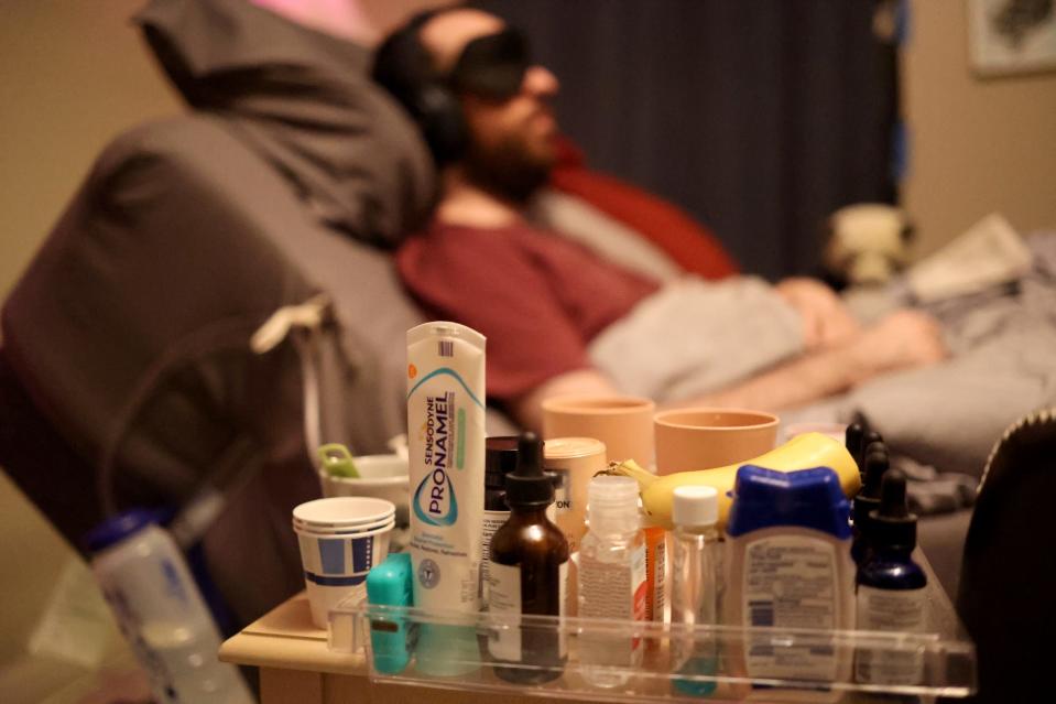 Everything from toothpaste to medications are at the ready by James Strazza's bedside.