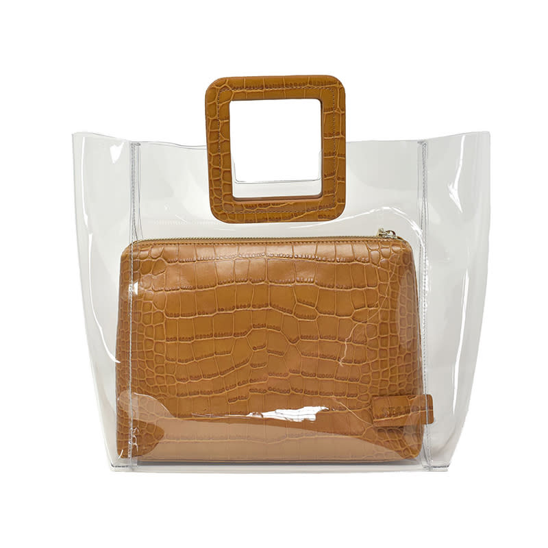 <a rel="nofollow noopener" href="https://staud.clothing/products/shirley-bag-clear-faux-croc" target="_blank" data-ylk="slk:Shirley Bag in Clear/Tan Faux Croc, Staud, $210Fashion girls left and right are going for the transparent trend with the clear Shirley tote.;elm:context_link;itc:0;sec:content-canvas" class="link ">Shirley Bag in Clear/Tan Faux Croc, Staud, $210<p>Fashion girls left and right are going for the transparent trend with the clear Shirley tote.</p> </a>