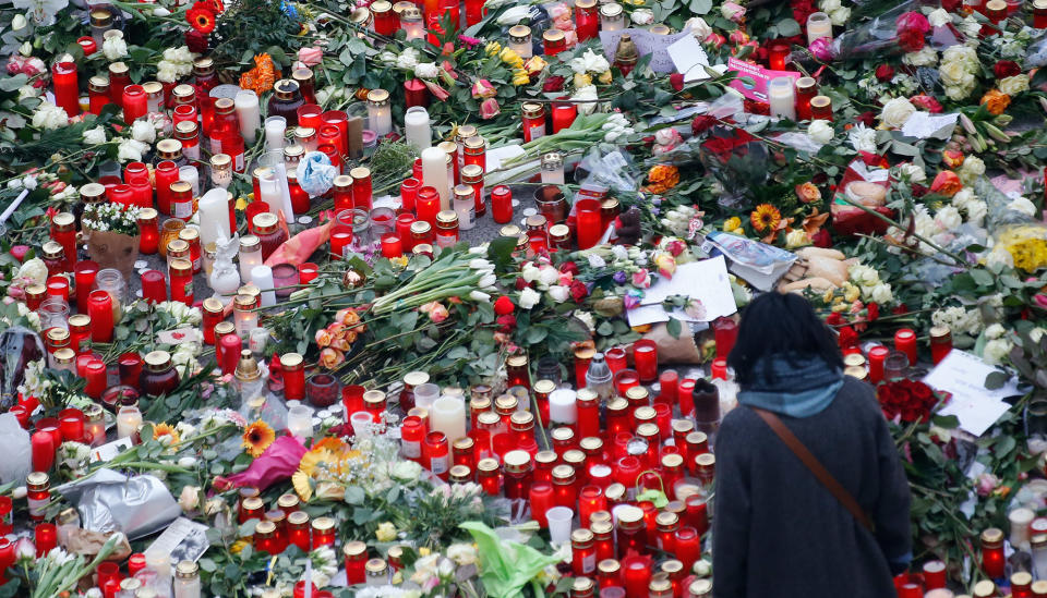 Flowers and candles are placed near the Christmas market in Berlin