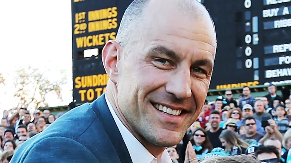 Pictured here, AFL legend Warren Tredrea does a lap of honour in front of fans.